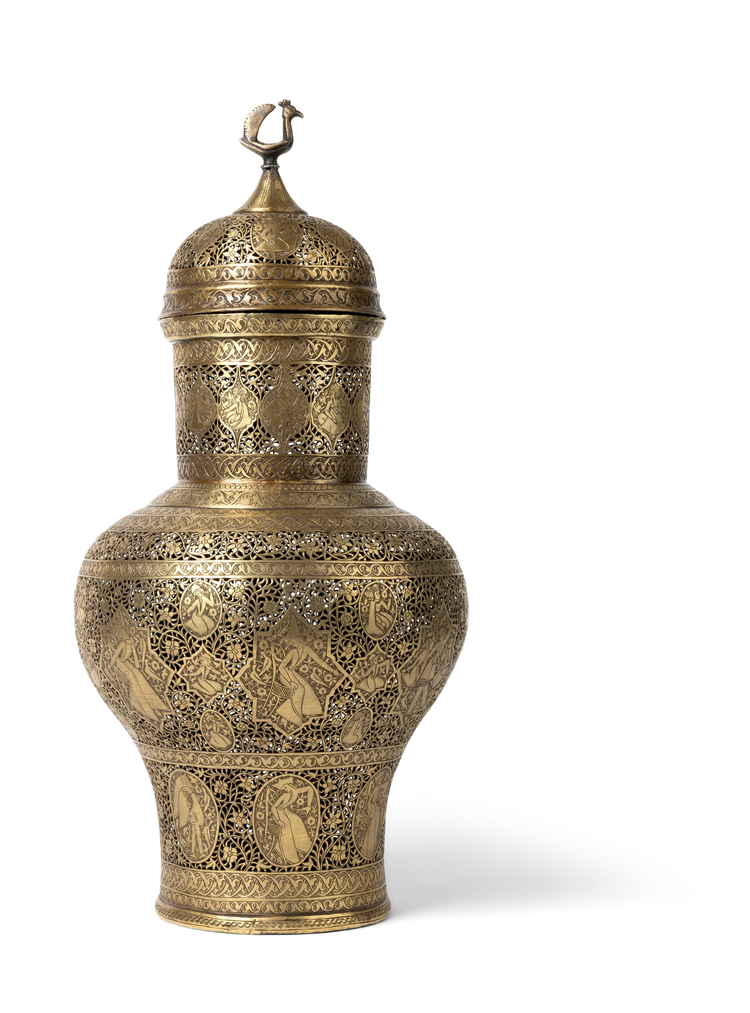 A TALL QAJAR BRASS INCENSE BURNER: A TALL QAJAR BRASS INCENSE BURNER PERSIA, 19TH CENTURY of tall baluster form, the domed-lid surmounted by a cockerel finial, the openwork body profusely decorated with various-shaped medallions and ca