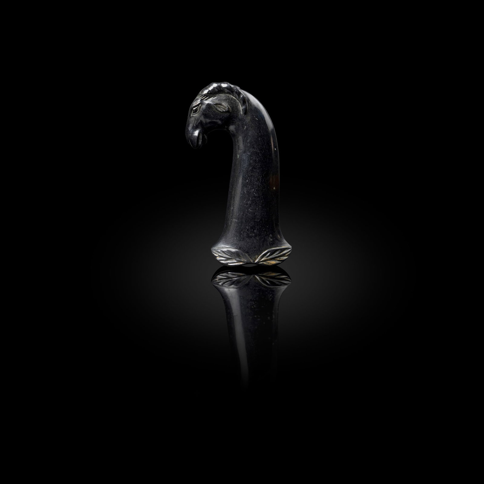 A FINE MUGHAL NEPHRITE HILT IN THE FORM OF A RAM'S HEAD (1 of 4)