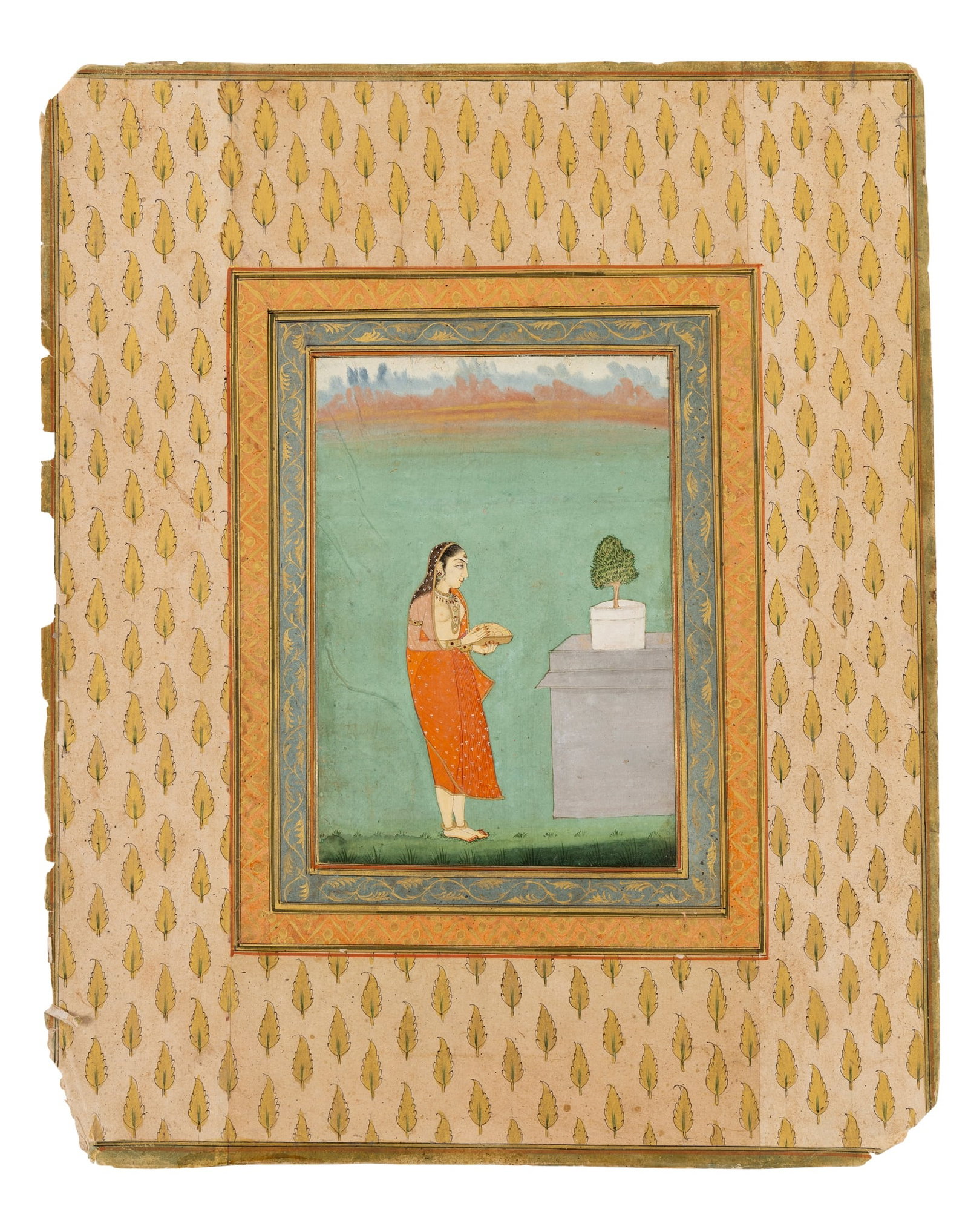 COURTESAN AT A LINGHAM SHRINE: COURTESAN AT A LINGHAM SHRINE MUGHAL INDIA, CIRCA 1760 gouache on paper heightened in gold, within gold and blue borders, mounted on an album page with gilt-floral lattice, a bare-breasted maiden rich