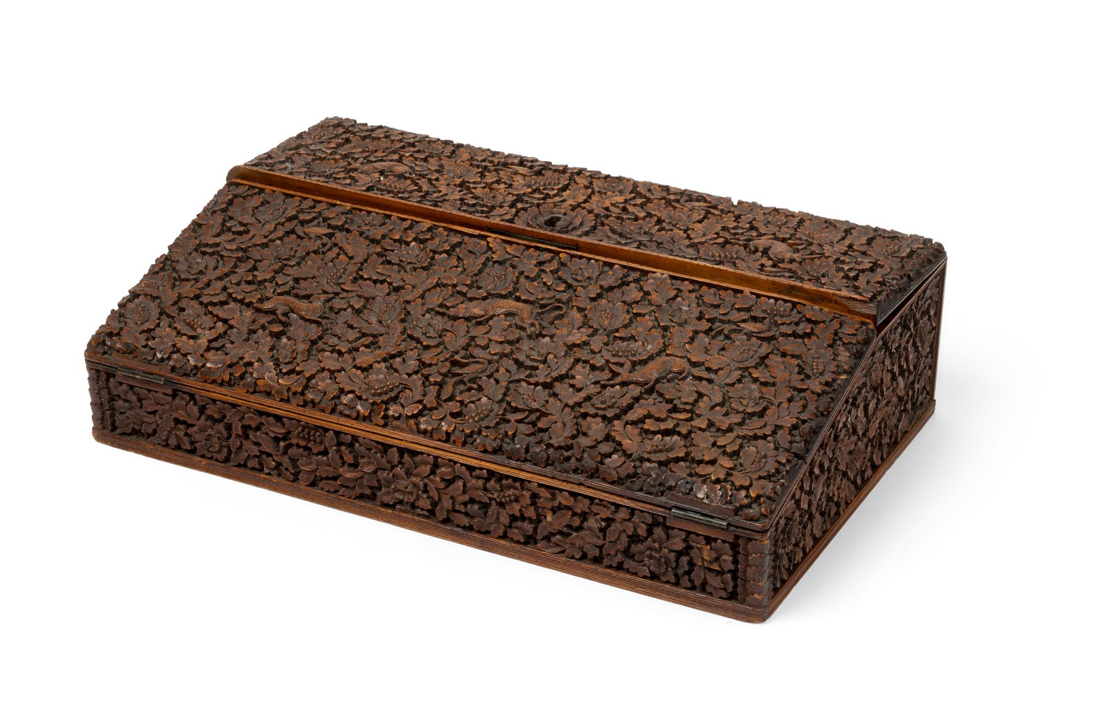 AN ANGLO-INDIAN CARVED SANDALWOOD WRITING BOX: AN ANGLO-INDIAN CARVED SANDALWOOD WRITING BOX INDIA, 19TH CENTURY of rectangular form with sloping hinged lid, the surfaces profusely carved in low relief with birds and animals within a multitude of 