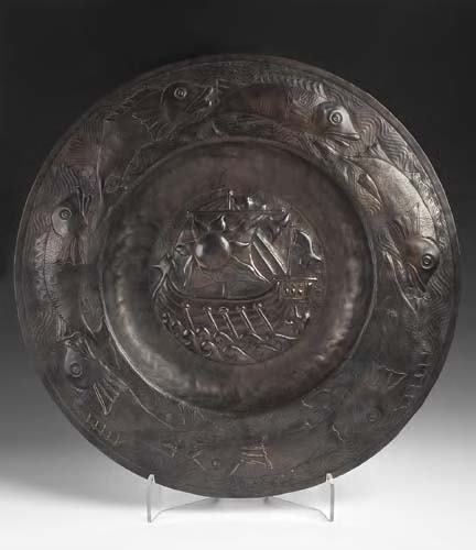 A large Newlyn style patinated copper charger: A large Newlyn style patinated copper charger, in the manner of John Pearson, of circular form, the central panel repousse decorated with a galleon in full sail, enclosed by a rim of swimming fish 61c