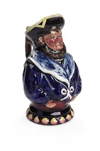 A Wemyss 'Jovial Sailor' toby jug, 28cm high: A Wemyss 'Jovial Sailor' toby jug, decorated by Eric Sandland, modelled as a sailor wearing blue nautical dress, the base moulded with shells, painted marks 'Wemyss ES' (minor damages) 28cm high
