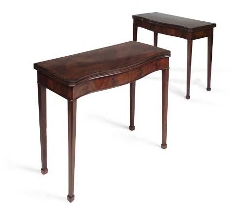 A pair of George III mahogany serpentine foldover: A pair of George III mahogany serpentine foldover tea tables, each with shaped rectangular top with rosewood crossbanding and moulded edge above flame veneered frieze, on tapering square section legs