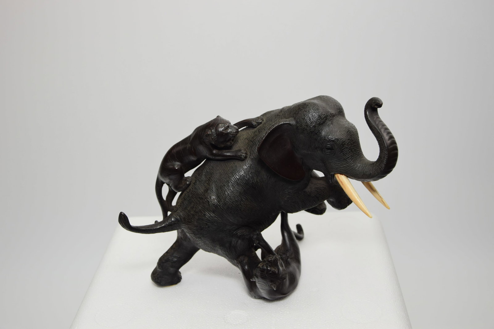 19th CENTURY JAPANESE MEIJI PERIOD BRONZE ELEPHANT OKIMONO, SIGNED: 19th CENTURY JAPANESE MEIJI PERIOD BRONZE ELEPHANT FULLY SIGNED. Modeling being attacked by tigers. Size: 7x 8 1/2in. All measurements are approximate. Condition: In-House Shipping Available. Please s