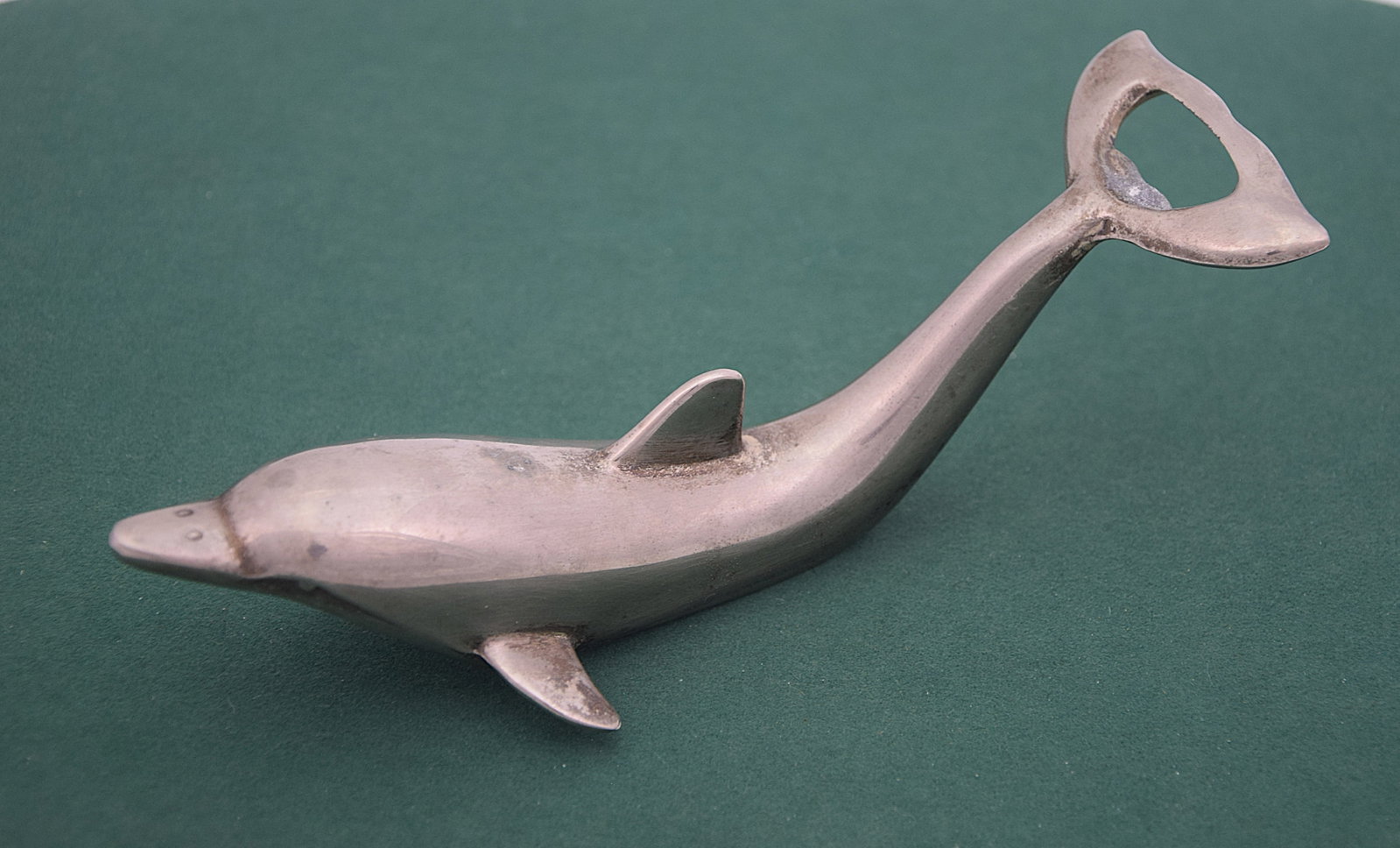 VINTAGE DOLPHIN FIGURINE/BOTTLE OPENER: Vintage Dolphin Figurine / Bottle Opener in stainless steel, nickel-plated. Good condition. Size: 6 x 2 in. All measurements are approximate. Condition: Please see pictures. Provenance: NY State promi