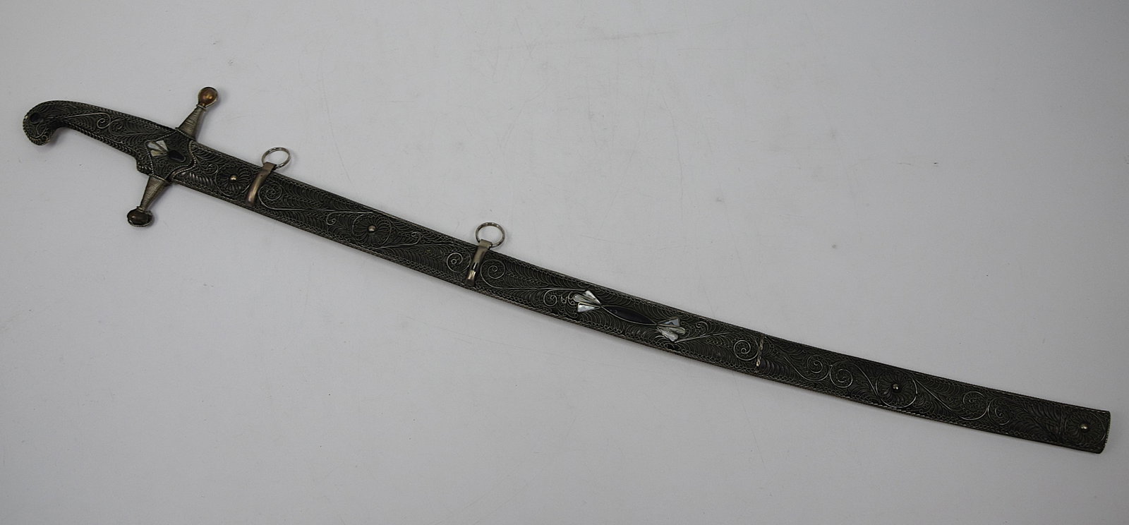 VINTAGE CAUCASIAN/ARAB STYLE SWORD: Vintage Caucasian or Arab Style Sword in Ornamental Scabbard with Mother-of-Pearl Inlays and Silver Filigree. Excellent condition. Size: 30 x 2 in. All measurements are approximate. Condition: Please 