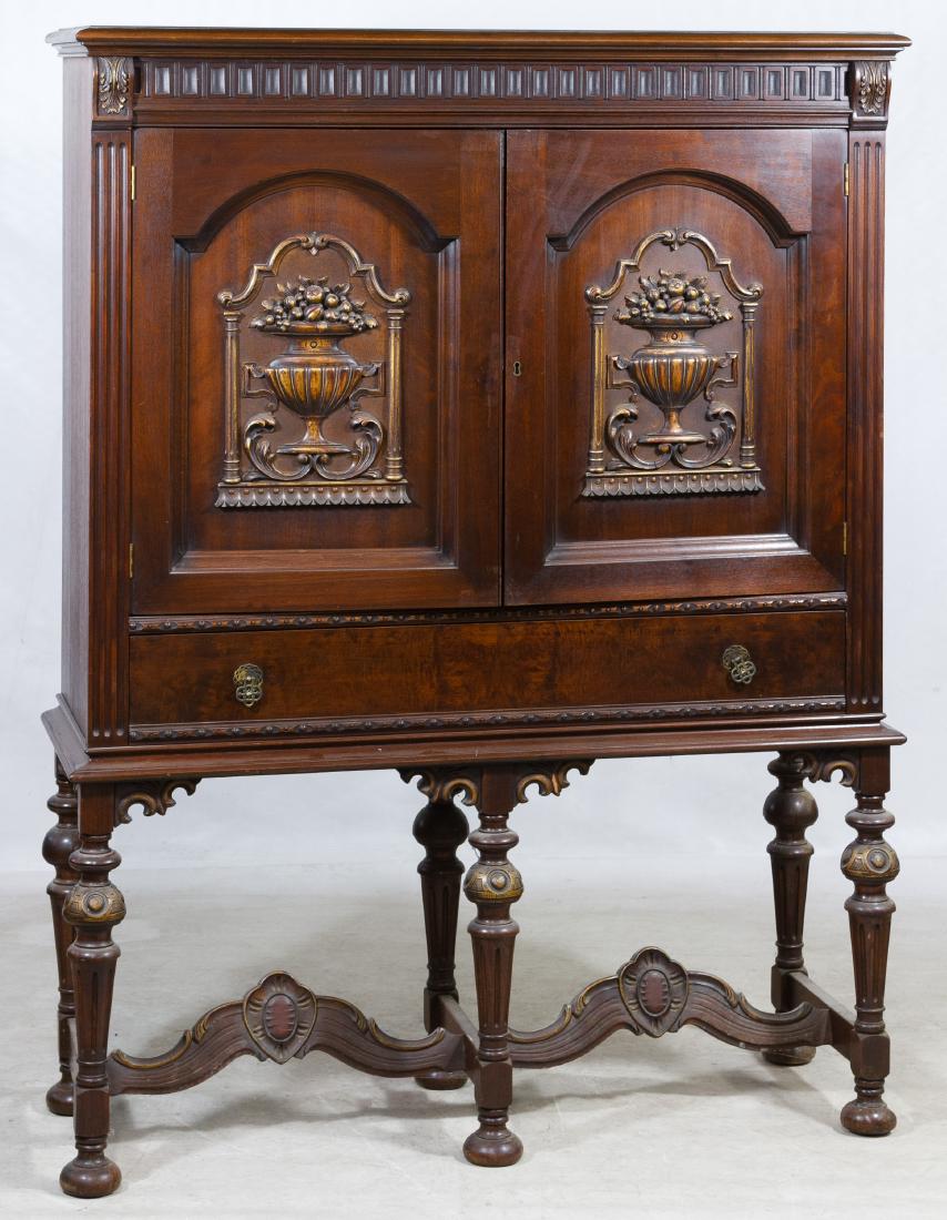 Classical Revival Mahogany Cabinet: Classical Revival Mahogany Cabinet Having applied urns on the cabinet doors, fluted pilasters and Rococo style stretchers; interior has two shelves; has a key Height: 63.00 inches, Width: 47.00 inches