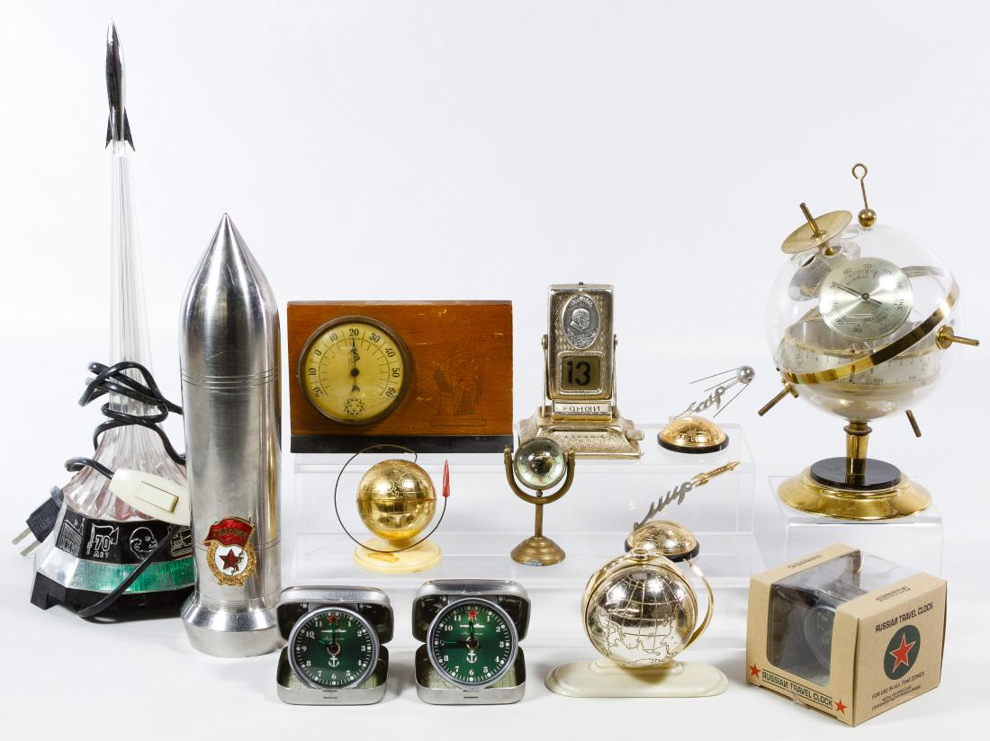 Desk Accessory Assortment: Desk Accessory Assortment Thirteen items including a Sputnik barometer, Sputnik items, travel clocks, light, metal rocket and wood barometer Height: 15.50 inches Category: Decorative Arts > Objects Sh