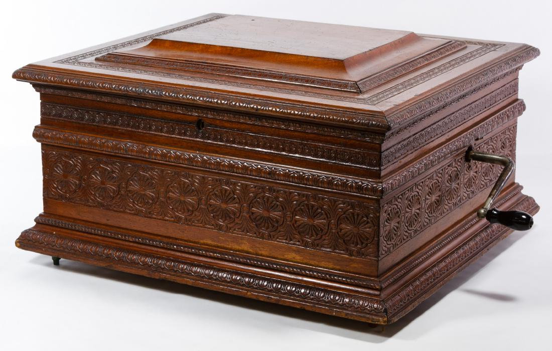 Criterion Carved Mahogany Disc Music Box: Criterion Carved Mahogany Disc Music Box c.1900, unmarked, includes crank, having a carved flower and scroll motif, (37) 15 3/4 inch discs marked Criterion Height: 12.00 inches, Width: 21.75 inches, D