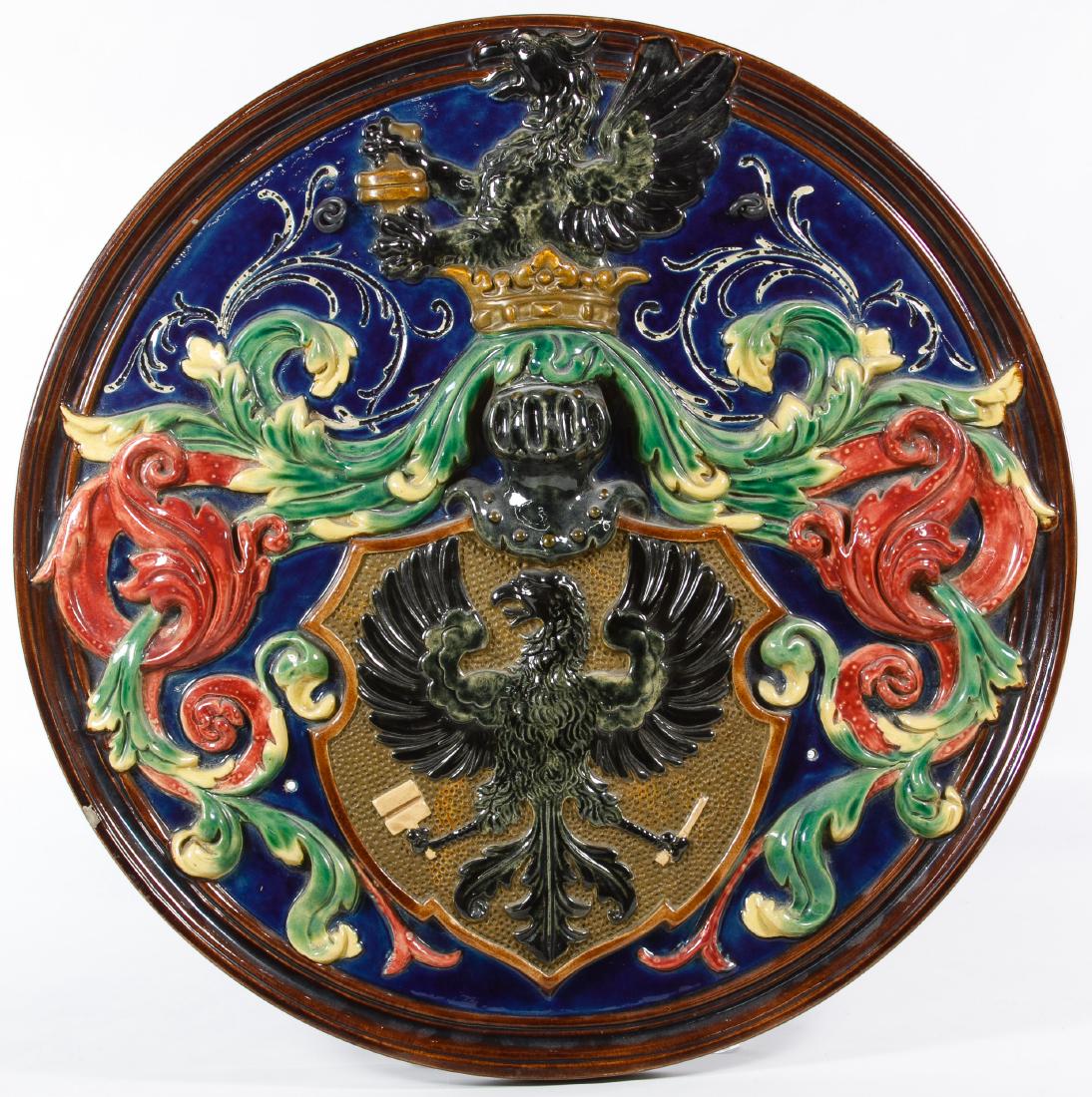 Majolica 'Eagle' Ceramic Wall Hanging: Majolica 'Eagle' Ceramic Wall Hanging 20th Century, unmarked, possibly produced by George Jones, depicting an eagle at the top and a eagle inside of a shield Height: 20.00 inches, Width: 20.00 inches,