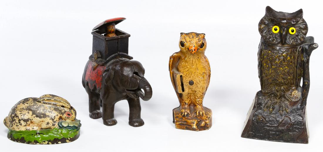 Cast Iron Mechanical Bank Assortment: Cast Iron Mechanical Bank Assortment Four items including a rabbit with moving ears, an eagle with moving eyes, an owl with moving head and an elephant with moving trunk and pop out rider Height: 7.75