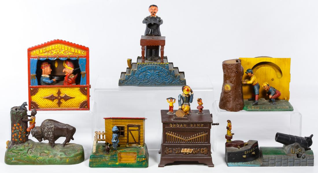 Reproduction Cast Iron Mechanical Bank Assortment: Reproduction Cast Iron Mechanical Bank Assortment Seven items reproduced from the 'Book of Knowledge' collection including Punch and Judy, the Frog Bank, the Organ Bank, Uncle Remus and the Magician B