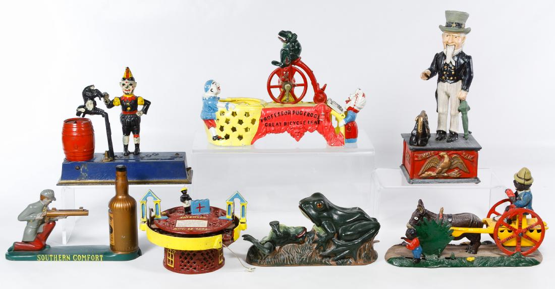 Cast Iron Mechanical Bank Assortment: Cast Iron Mechanical Bank Assortment Seven items including (3) replica marked banks: Mother Goose Circus, Race Course and two frogs; a Taiwan marked mule bank, a Southern Comfort advertising bank and 