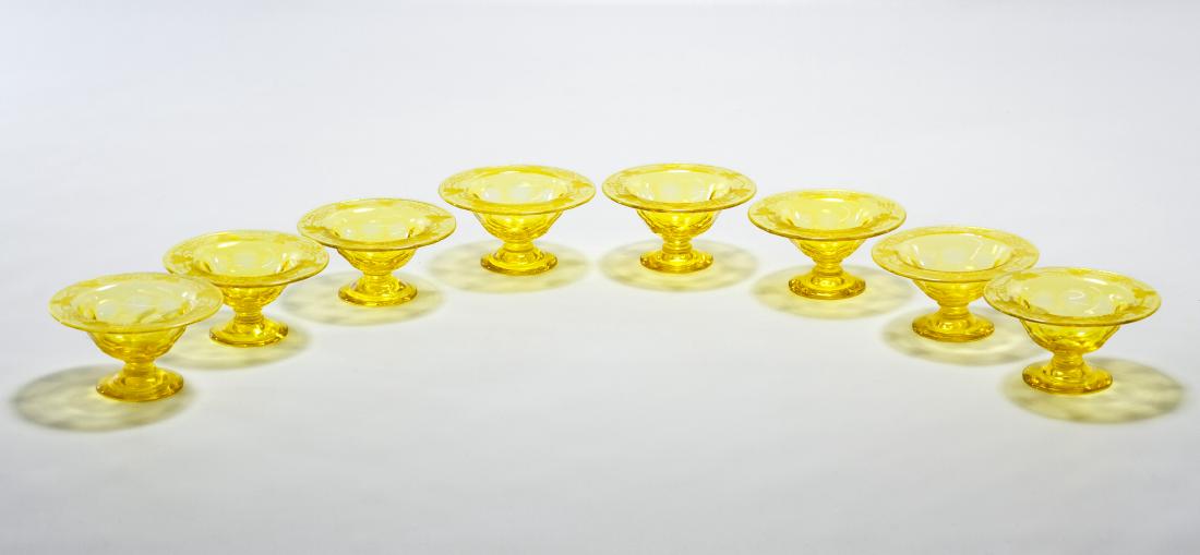 Steuben Glass 'Bristol Yellow' Salt Cellars: Steuben Glass 'Bristol Yellow' Salt Cellars c.1920, set of eight, signed on foot, etched grape design; including 1993 authentication letter from The Rockwell Galley Height: 1.50 inches, Width: 3.00 in