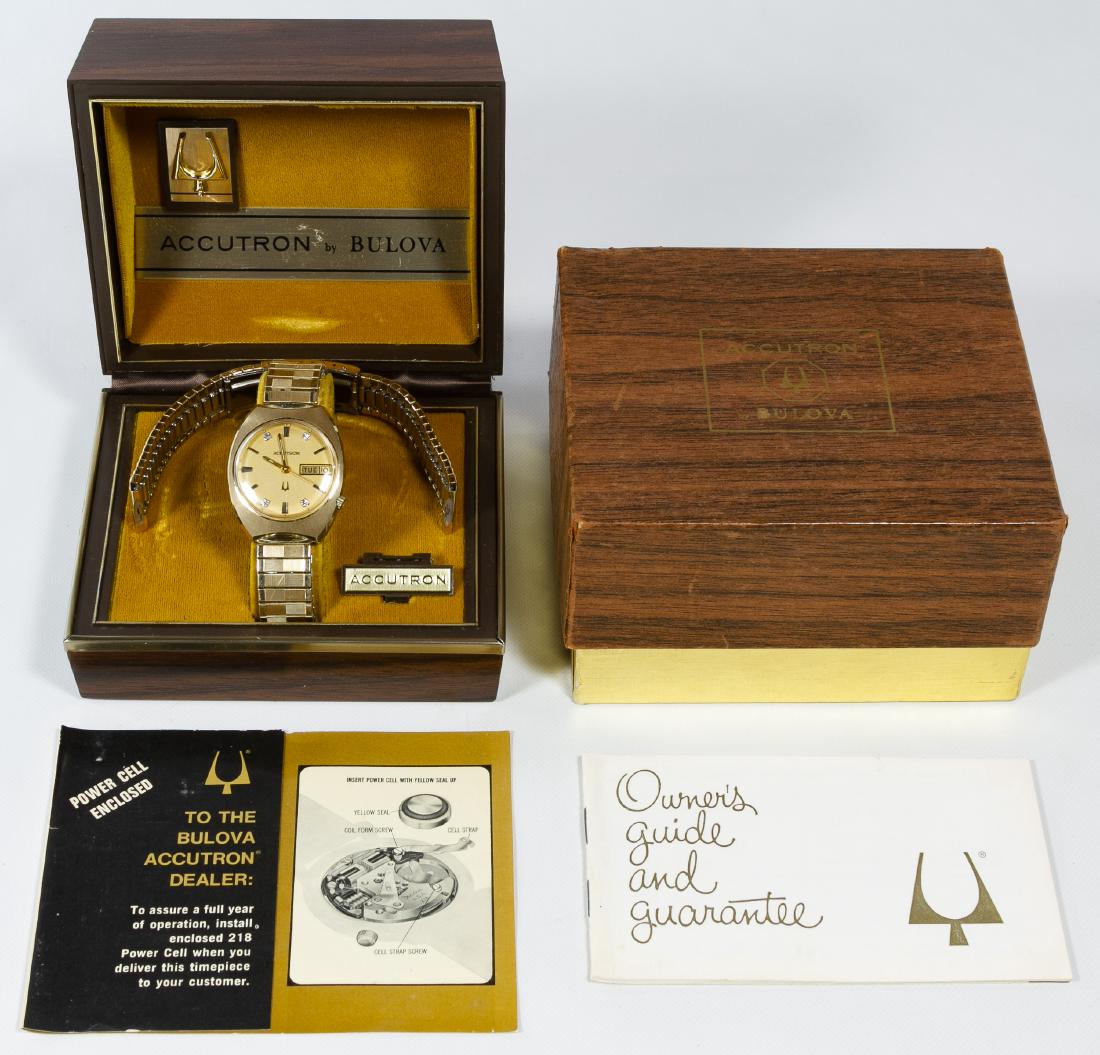 Bulova 14k Gold Case 'Accutron' Men's Wrist Watch: Bulova 14k Gold Case 'Accutron' Men's Wrist Watch Having day and date feature on replacement band; marked '14k gold case' on back plate; together with original box, instructions and original band Leng