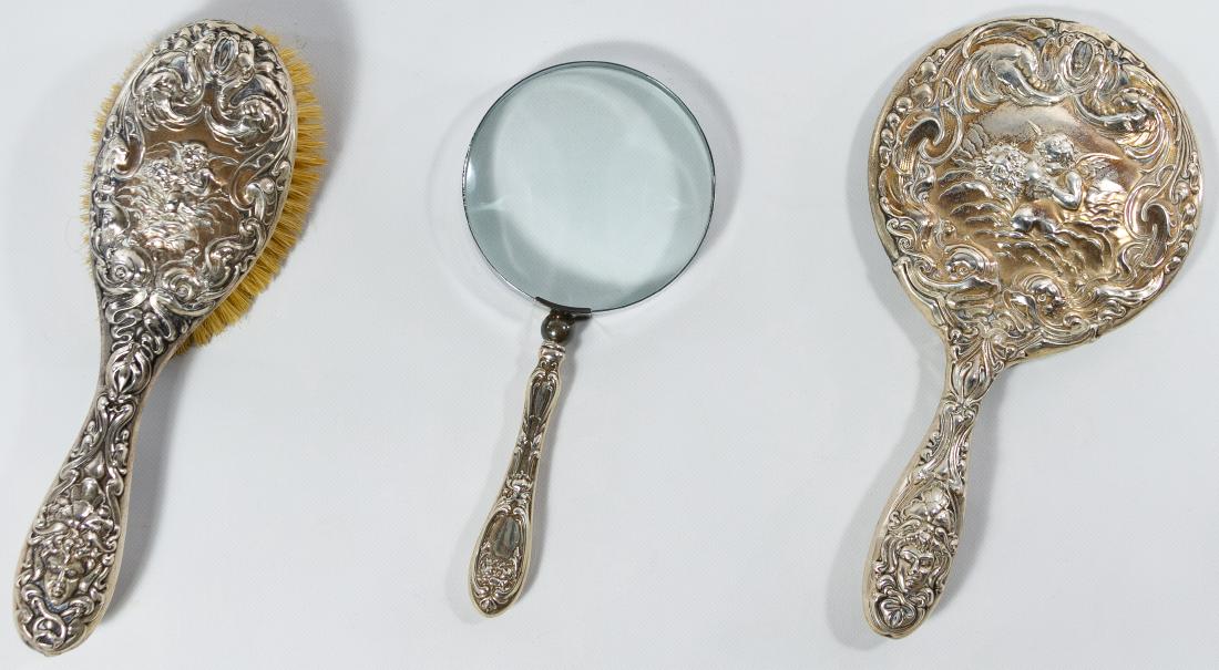 Sterling Silver Brush, Mirror and Magnifying Glass: Sterling Silver Brush, Mirror and Magnifying Glass Three items including two having cherub motif; all marked 'sterling' Length: 9.25 inches (mirror) Category: Silver & Metalware > Sterling Silver Obje