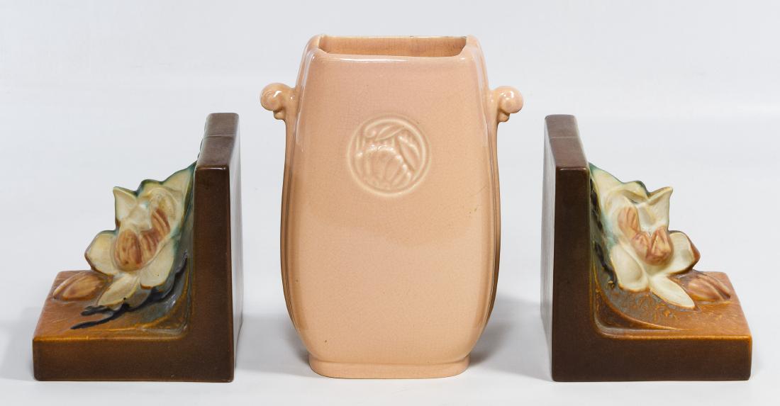 Roseville #13 'Magnolia' Pottery Bookends: Roseville #13 'Magnolia' Pottery Bookends Both marked on the undersides; together with a pottery vase by Abingdon Height: 7.75 inches (vase) Category: Pottery & Porcelain > Roseville Shipping Status: 