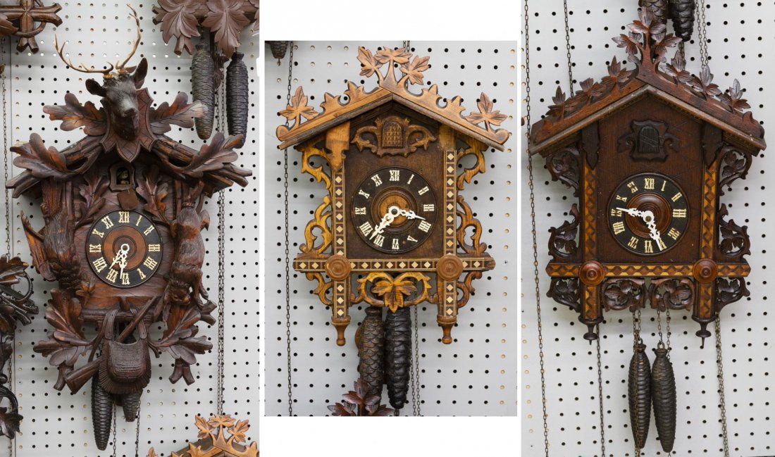 Black Forest Style Wooden Cuckoo Clocks: Black Forest Style Wooden Cuckoo Clocks Three clocks including one with an animal motif; all having weights Height: 19.50 inches, Width: 16.00 inches, Depth: 7.75 inches (tallest) Category: Decorative
