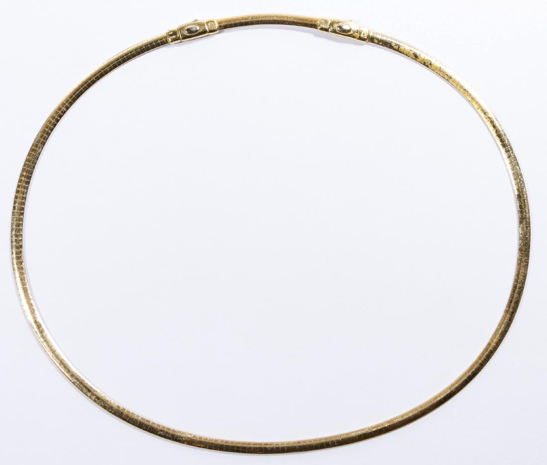 14k White / Yellow Gold Omega Link Necklace: 14k White / Yellow Gold Omega Link Necklace Double sided necklace having white gold on one side and yellow gold on the other, measuring approximately 5mm in width; together with a 2-inch extension; bo