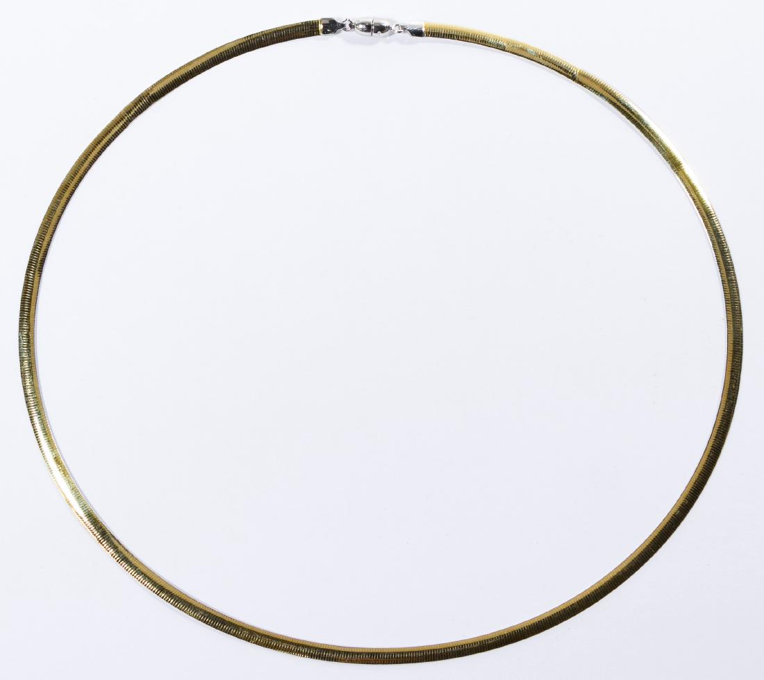 14k White / Yellow Gold Omega Link Necklace: 14k White / Yellow Gold Omega Link Necklace Double sided necklace having white gold on one side and yellow gold on the other, measuring approximately 4mm in width; magnetic clasp; marked '14k' near cl