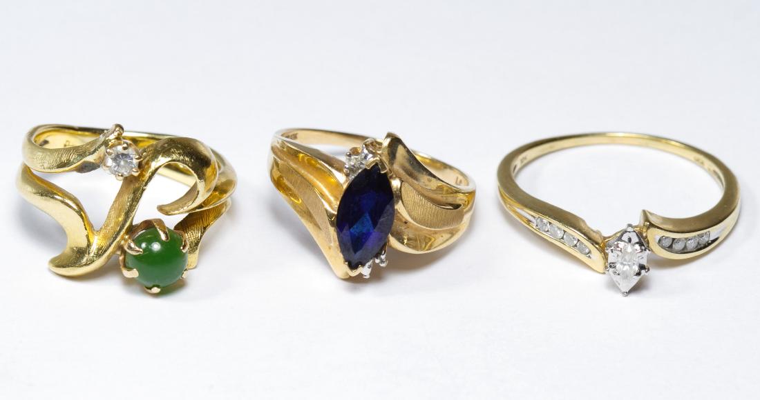 10k Gold and Gemstone Rings: 10k Gold and Gemstone Rings Three rings, one having a round cut cabochon green quartz, another having a marquis cut sapphire, the third having a marquis cut diamond, all adorned with small round cut d