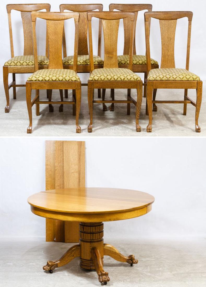 Oak Round Table and Six Chairs: Oak Round Table and Six Chairs Extendable pedestal table with claw feet, three leaves and custom pads together with six oak T-back chairs having upholstered seats Height: 29.00 inches, Diameter: 48.00