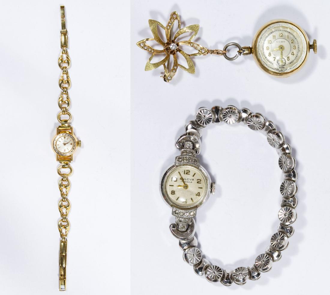 Lemania 18k Gold Case Wrist Watch: Lemania 18k Gold Case Wrist Watch Having a 17-jewel Swiss movement on a gold filled band; marked '18k' and '.750' inside back of case; together with a 10k gold watch pin with Cort pendant watch having