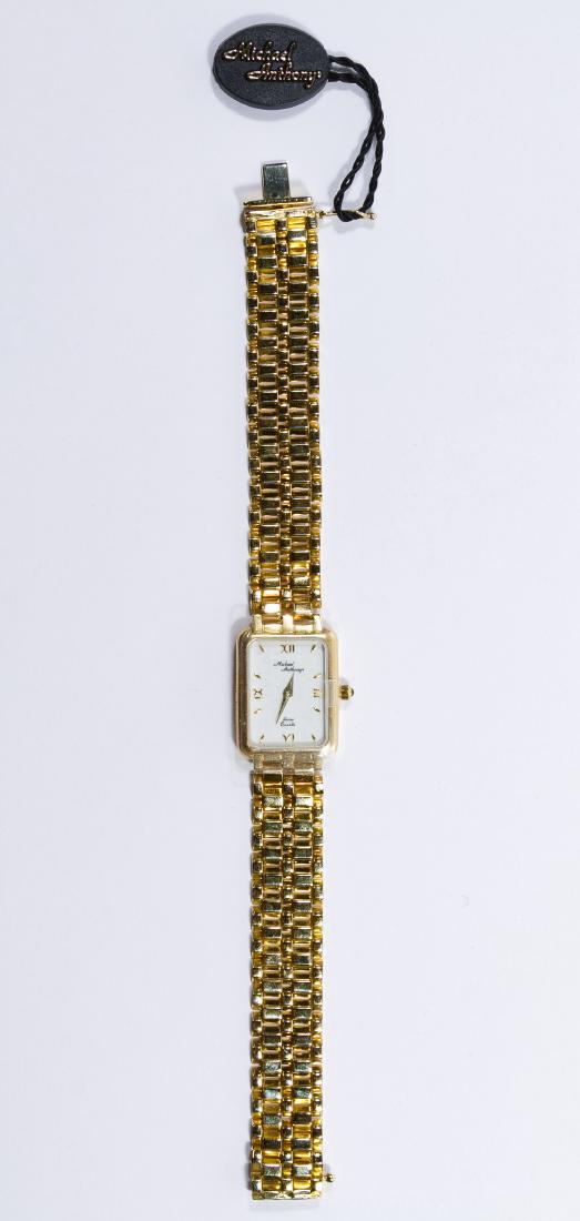 Michael Anthony 14k Gold Case and Band Wrist Watch: Michael Anthony 14k Gold Case and Band Wrist Watch Marked '14k' on back of case and band clasp; having a quartz movement; together with storage box and name tag Length: 7.25 inches Weight: 0.82 ozt. (