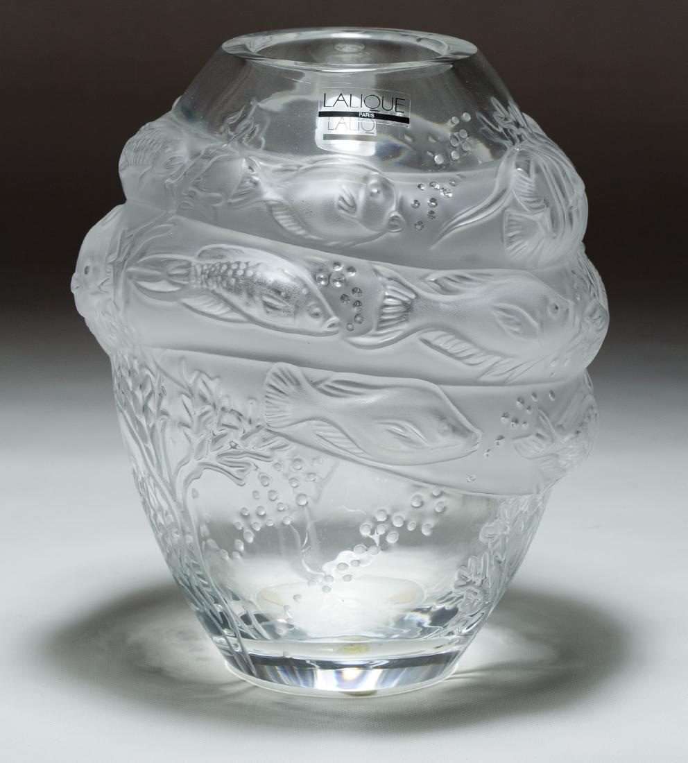 Lalique Crystal 'Marina' Vase: Lalique Crystal 'Marina' Vase Having a fish design; signed on bottom; together with original box, paperwork and packaging Height: 7.00 inches, Diameter: 5.50 inches Category: Crystal & Glass > Lalique