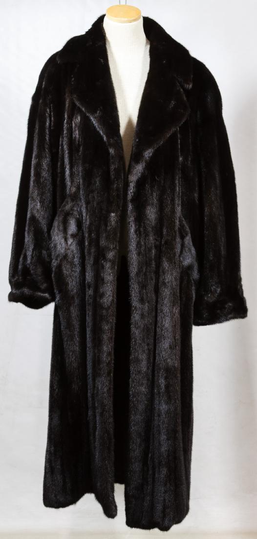 Black Mink Fur Full Length Coat by I Magnin: Black Mink Fur Full Length Coat by I Magnin Having a Carol and Irwin Ware for I Magin label, black satin lining, interior belt, sewn on name plate, a detachable exterior belt and a 1988 appraisal from