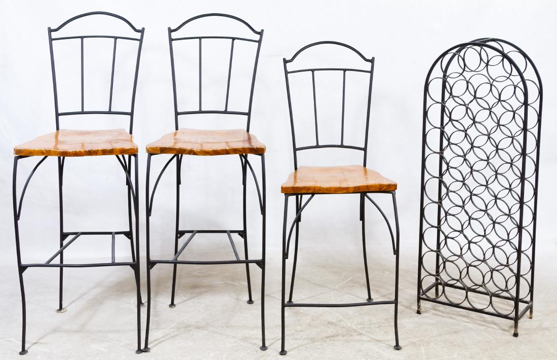 Wrought Iron and Pine Bar Stools: Wrought Iron and Pine Bar Stools Including two tall and one shorter bar stools; together with a cast iron wine rack by Arthur Umanoff Height: 47.00 inches, Width: 17.00 inches, Depth: 22.00 inches (ta