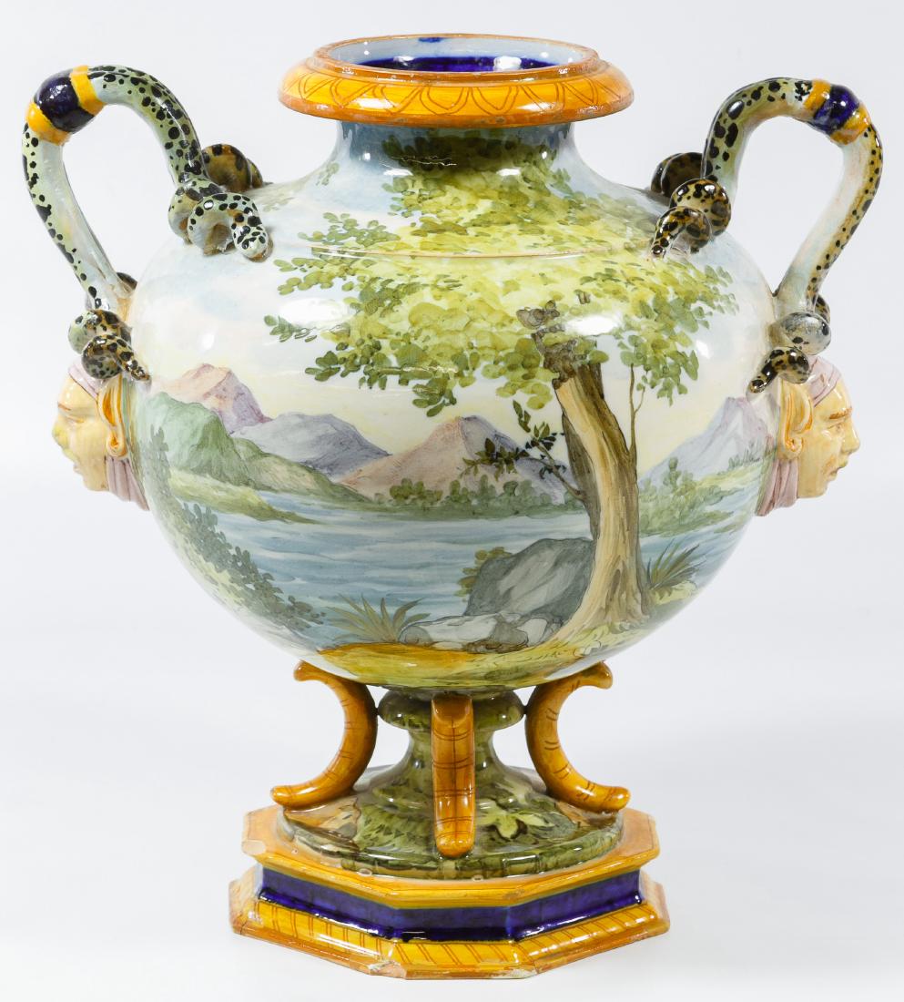 Ginori Italian Hand Painted Urn: Ginori Italian Hand Painted Urn Marked on the underside 'Ginori 64-1104' and having a hand painted scene of two females; and mask face and snake style handles Height: 11.50 inches, Width: 10.00 inches