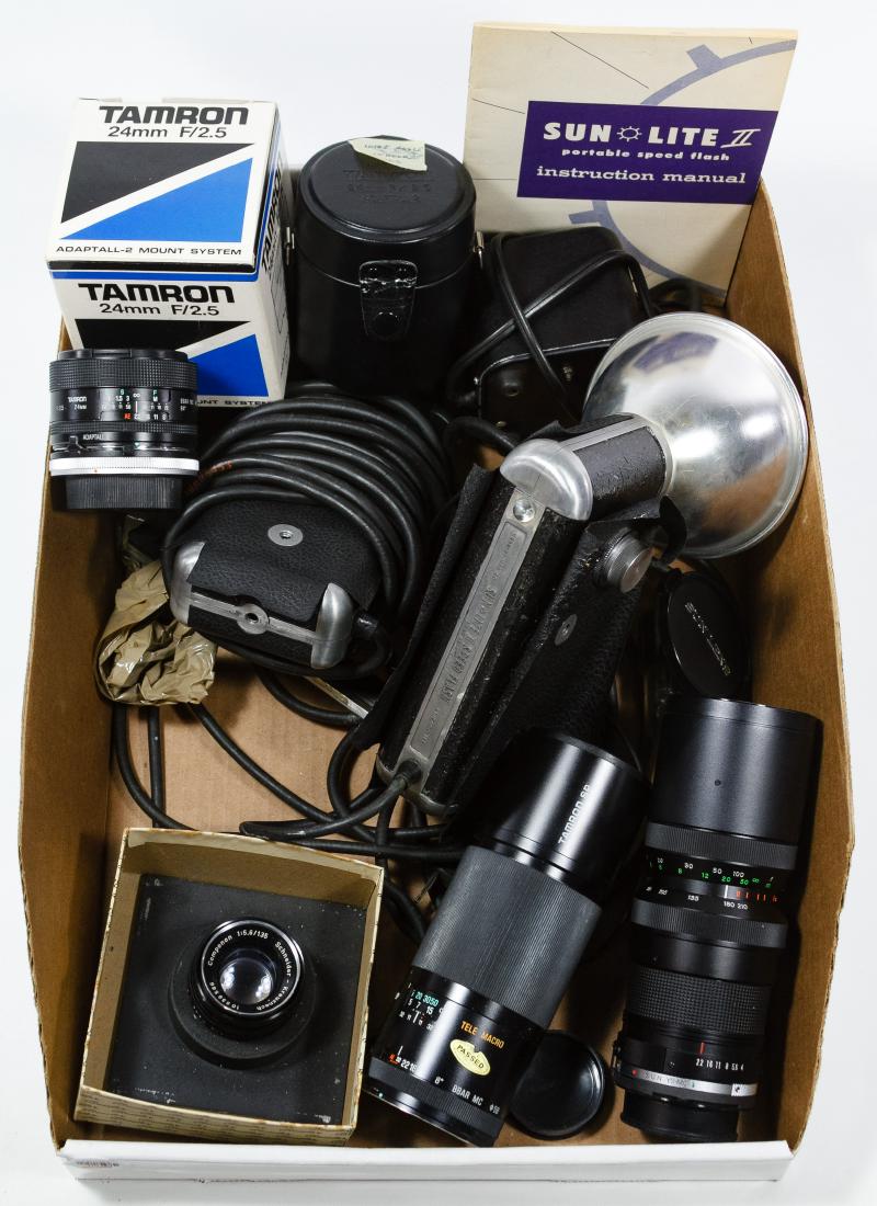 Camera Lens and Accessory Assortment: Camera Lens and Accessory Assortment Seven items including Tamron 24mm lens with box, Tamron SP lens, Sun Opt. 70-210mm lens, Schneider Kreuznach Componon 135mm lens, (2) Sun Lite speed flashes and a