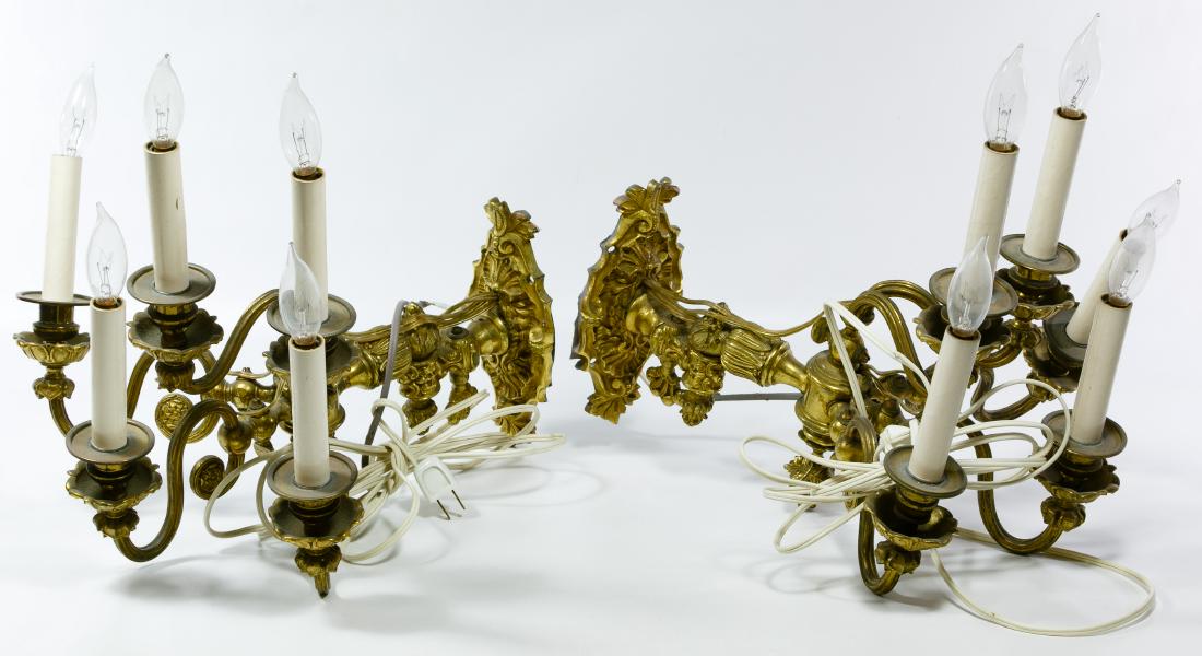 Gilt Brass Electrified Wall Sconces: Gilt Brass Electrified Wall Sconces Including a pair of 5-arm wall sconces with classical detailing Height: 20.00 inches, Width: 15.00 inches, Depth: 14.00 inches (each sconce) Category: Decorative Ar
