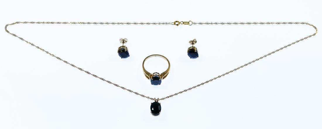 14k Gold and Sapphire Jewelry Suite: 14k Gold and Sapphire Jewelry Suite Including a pair of earrings, ring, pendant on necklace, all having oval cut sapphires; most marked '14k'; together with a Marshall Field's storage box Length: 20.0