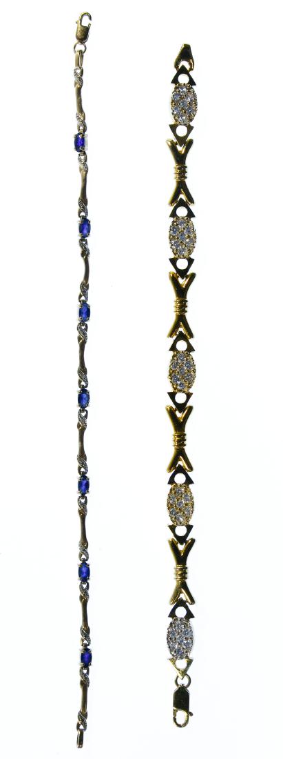 10k Gold and Gemstone Bracelets: 10k Gold and Gemstone Bracelets Two bracelets with one having oval cut sapphires and a few very small round cut diamonds and the other having round cut clear crystals; both marked '10k' on the clasp L