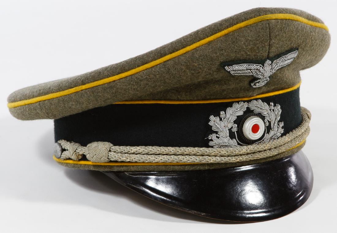 World War II German Cavalry Officer Peaked Cap: World War II German Cavalry Officer Peaked Cap Having a grey green wool construction with visor, black wool band, braid trim, silver metallic eagle with swastika, an 'Original Schellenberg Walter Bunn