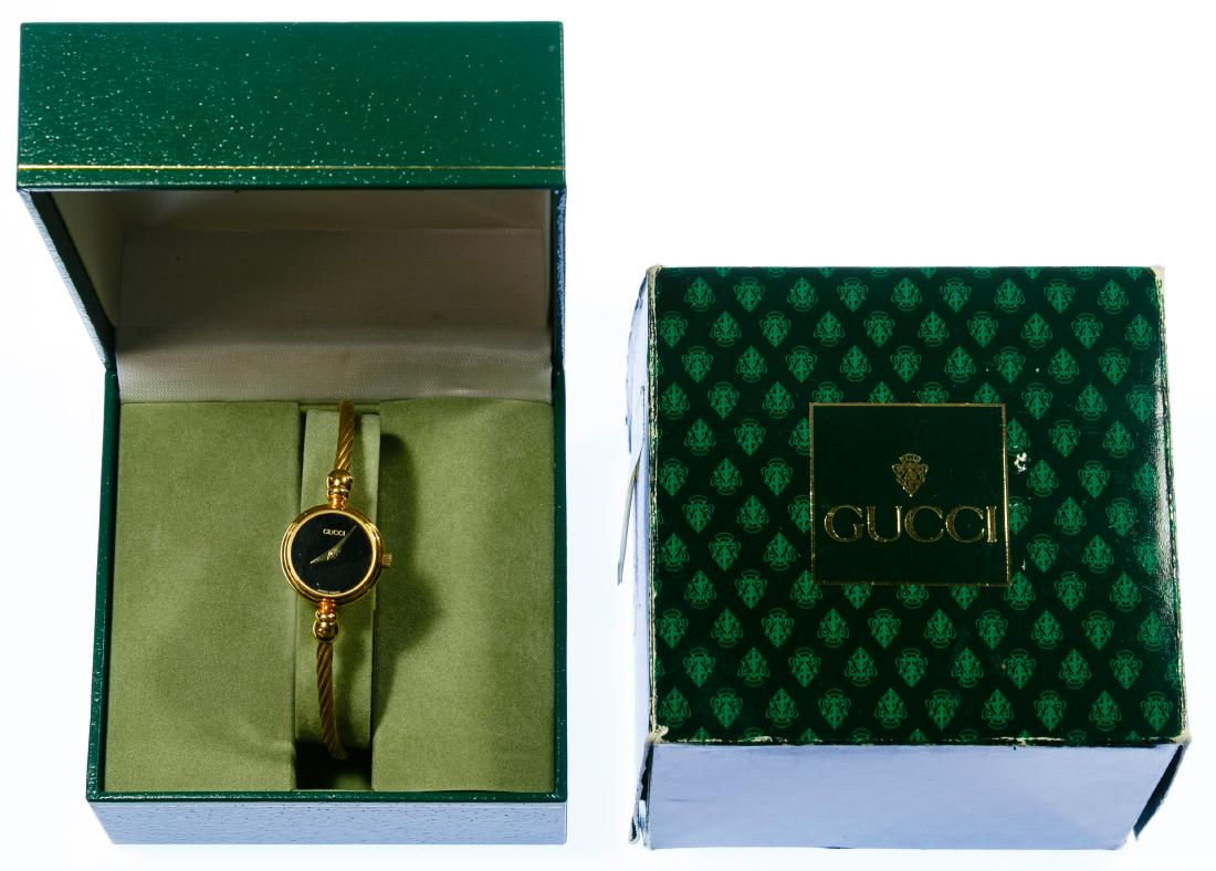 Gucci Ladies Gold-tone Lasso Rope Watch: Gucci Ladies Gold-tone Lasso Rope Watch Model 2700.2.L, serial #0127242 having a round black face, stem wind and set; together with boxes Length: 5.50 inches (adjustable) Category: Watches > Women's W