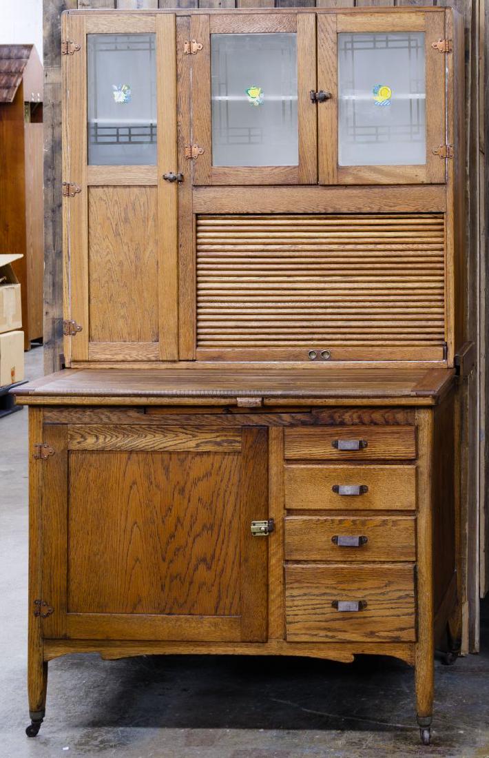 Pine Hoosier Cabinet: Pine Hoosier Cabinet Top having a full length wood framed glass door next to a pair of partial wood framed glass doors over a tambour door, all over a work surface, over a pull out shelf, over a wood