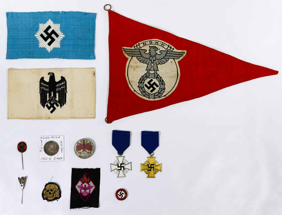 World War II German Medal, Banner and Pin Assortment: World War II German Medal, Banner and Pin Assortment Including a NSKK banner, an eagle armband, a swastika armband, a 1944 Wehrmann pin, an enamel DAP pin, an enamel AV pin, an eagle stick pin, two se