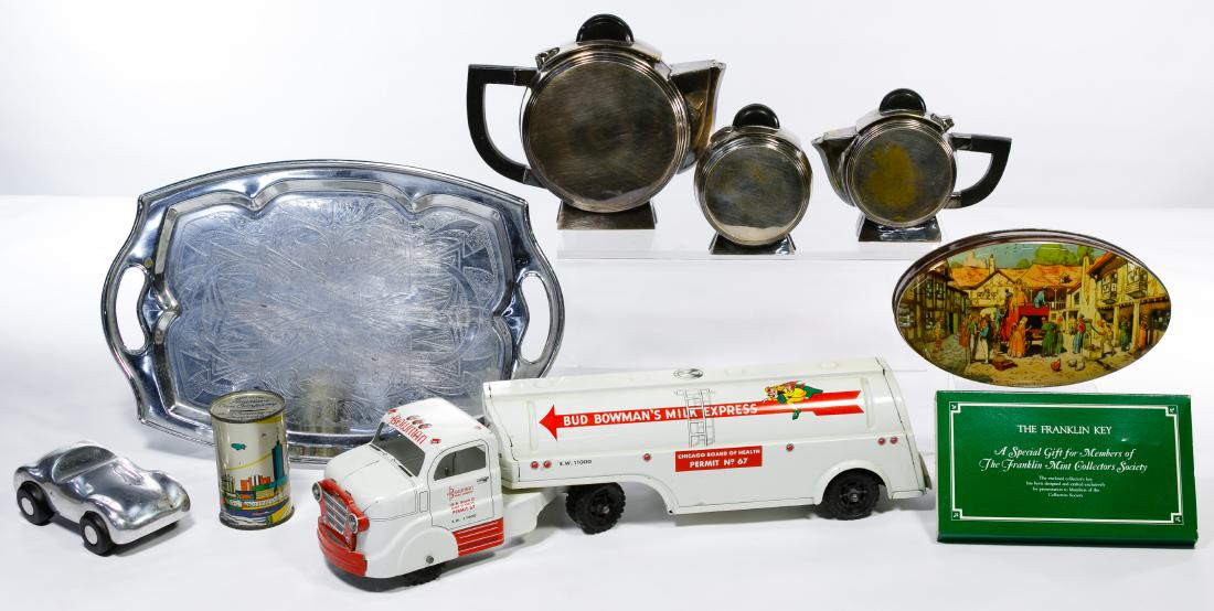 Metalware Assortment: Metalware Assortment Nine items including an Art Deco tea set with tray; cast aluminum roadster by Orskov & Co. designed by Jorgen Moller; Century of Progress American Can Co. coin bank; Franklin Mint