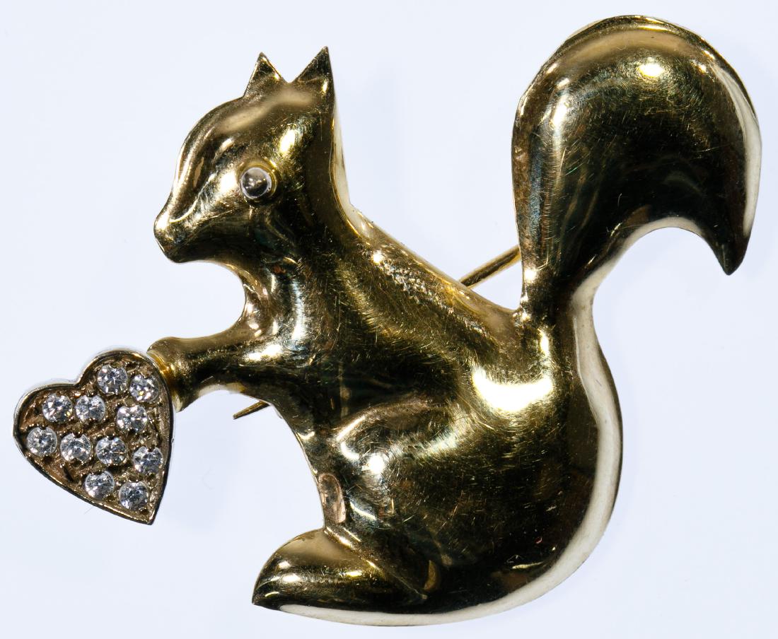 14k Gold and Crystal Squirrel Brooch: 14k Gold and Crystal Squirrel Brooch Pin in the form of a squirrel holding a heart adorned with clear crystals; marked '14k' on back Height: 1.25 inches, Width: 1.75 inches Weight: 2.51 dwts. (total w