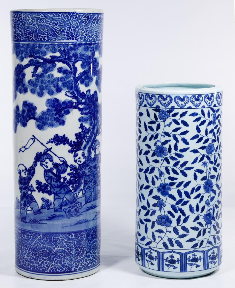Asian Blue and White Umbrella Stands: Asian Blue and White Umbrella Stands Two stands, unmarked, largest having a figural landscape scene, smaller having an overall floral design Height: 23.50 inches, Diameter: 8.25 inches (largest) Categ