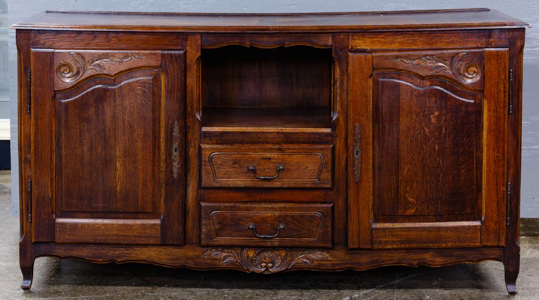 Country French Elm Buffet: Country French Elm Buffet Having hand carved detail, bronze hardware and locking side doors with key; the two center drawers are dovetailed Condition: Good, reinforced left cabinet door; left side mis