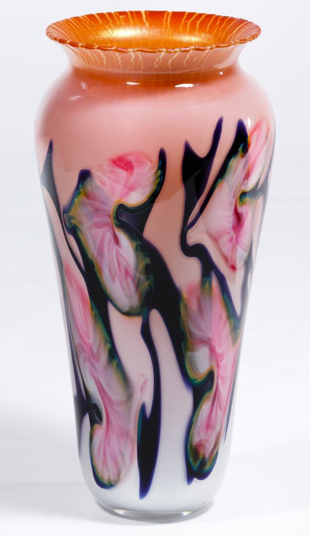 John Lotton Art Glass Vase: John Lotton Art Glass Vase 1991, etched signature to underside, depicting stretched floral design, navy, green, pink, gold, white Condition: Very Good, no scratches or chips noted Height: 11.50 inches
