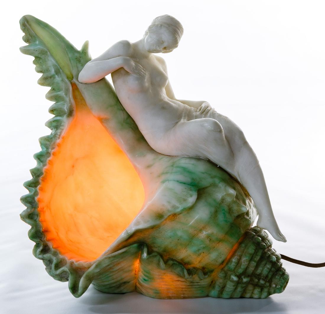 Emilio P Fiaschi (Italian, 1858-1941) Carved Alabaster: Emilio P Fiaschi (Italian, 1858-1941) Carved Alabaster Table Lamp Undated, signed on the underside, depicting a nude female lounging on a shell Condition: Good, a small chip along the front shell edge