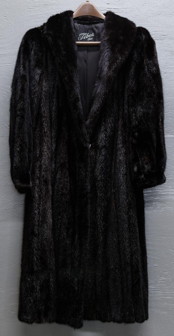 Mink Fur Coat: Mink Fur Coat Labeled Tibor Furs, having vertical pelts throughout, trapunto stitching and monogram on the lining, pelts supple Condition: Very Good, minor wear on right cuff, no dryness noted Length: