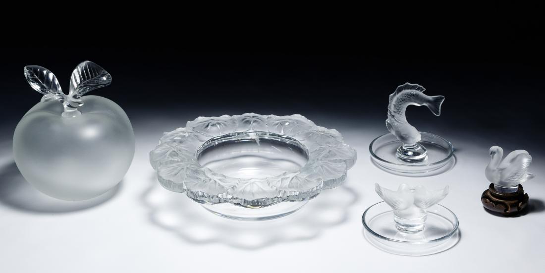 Lalique Crystal Assortment: Lalique Crystal Assortment Six items including a 'Honfleur' wine coaster, a 'Grande Pomme' perfume bottle, a mini swan figurine, and two ring trays including a fish and a lovebird figurine on top, all