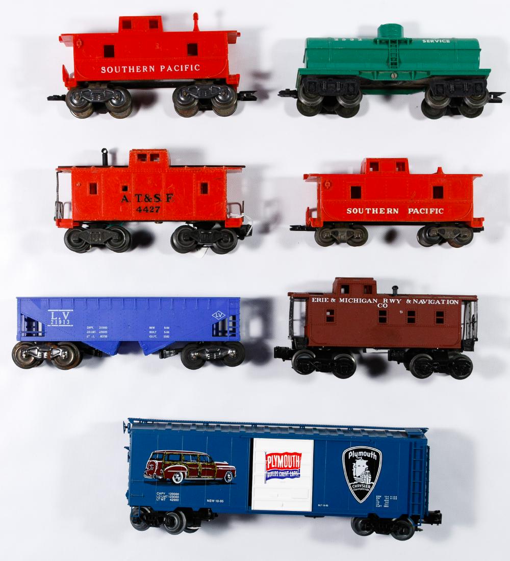 Model Train Assortment: Model Train Assortment Twenty-four plastic, 'O' gauge, including Lionel, Marx and K-Line, examples of passenger, box, flat cars and cabooses Condition: Good, scratches, detached, missing or broken pie