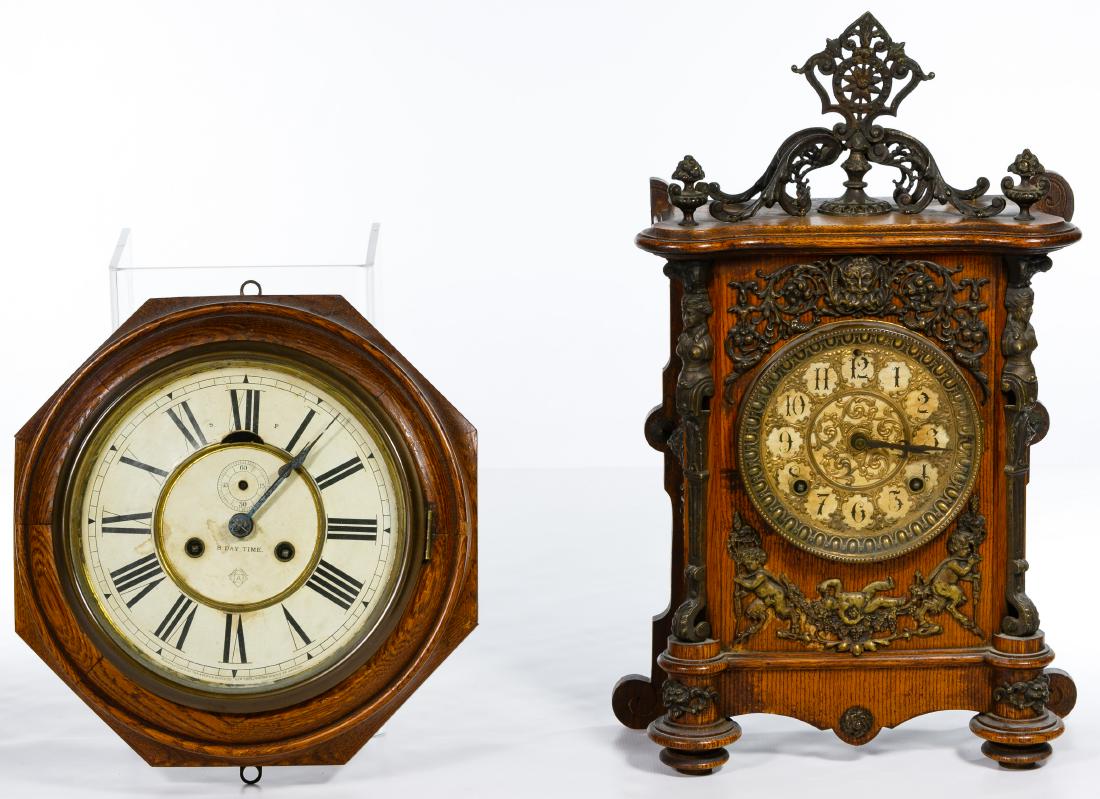 Ansonia Mantle and Wall Clocks: Ansonia Mantle and Wall Clocks Two wooden clocks by Ansonia, an oak wall clock with brass and an oak mantle clock, decorated in brass depicting Baccus Condition: Good, hinge is broken on glass of mant